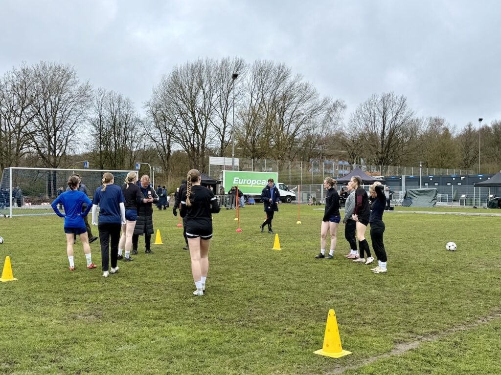 Fußballspielerinnen im Halbkreis auf dem Platz